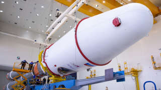 This handout photograph taken and released by the Russian Space Agency Roscosmos on August 7, 2023, shows technicians finishing to assemble a Soyuz 2.1b rocket carrying the Luna-25 lander ahead of its launch scheduled for August 11, 2023, at the Vostochny cosmodrome, some 180 km north of Blagoveschensk, in the Amur region. Russia said on August 7, 2023 it plans to launch a lunar lander later this week after multiple delays, hoping to return to the Moon for the first time in nearly fifty years. (Photo by Handout / Russian Space Agency Roscosmos / AFP) / RESTRICTED TO EDITORIAL USE - MANDATORY CREDIT 