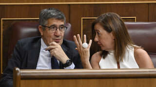 Socialist group's candidate for speaker, Francina Armengol (R), talks with Socialist MP Patxi Lopez as they attend the Parliament's constitutive sitting at the Congress of Deputies in Madrid on August 17, 2023. Spain's parliament reconvenes today after an inconclusive July general election to vote on a new speaker for the chamber, which is widely seen as a trial run ahead of a crucial investiture vote -- that determines who forms the government -- expected next month. (Photo by JAVIER SORIANO / AFP)
