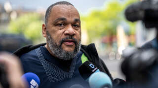 French controversial humorist Dieudonne MBala MBala talks to the press as he arrives to testify on the second day of Tariq Ramadan's trial at the Geneva court house on May 16, 2023. Swiss Islamic scholar Tariq Ramadan is on trial in Geneva charged with 