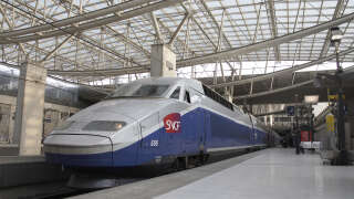 SNCF train with passengers on platform in TGV railway station at Charles De Gaulle International Airport Paris, France
