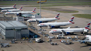 British Airways jets are seen at Heathrow Airport June 13, 2021, in west London. (Photo by Brendan Smialowski / AFP)