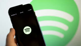 This illustration photo shows the Spotify logo on a smartphone in Washington, DC, on January 31, 2022. Shares of Spotify tumbled Wednesday after the music streaming service -- roiled in controversy over its star podcaster Joe Rogan -- projected lower profit margins in the coming earnings period as subscriber growth slows.
The company reported solid increases in the fourth quarter in terms of monthly active users and 180 million premium subscribers, in line with earlier forecasts. (Photo by Stefani Reynolds / AFP)