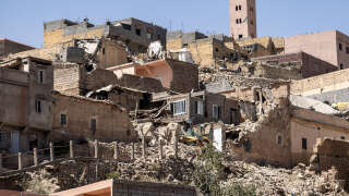 The minaret of a mosque stands behind damaged or destroyed houses following an earthquake in Moulay Brahim, Al-Haouz province, on September 9, 2023. Morocco's deadliest earthquake in decades has killed at least 1000 people, officials said on September 9, causing widespread damage and sending terrified residents and tourists scrambling to safety in the middle of the night. (Photo by FADEL SENNA / AFP)