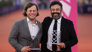 US film director Shane Atkinson (L) poses with the Public award, Critic award and Grand Prix for the movie 