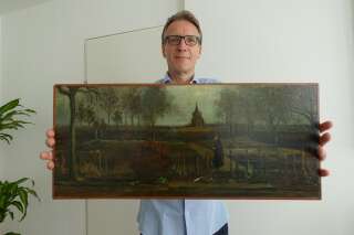 An handout picture released by Dutch art detective Arthur Brand shows a portrait of him posing with the painting title 