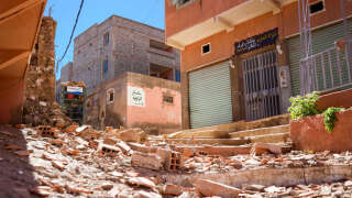 MOULAY BRAHIM, MOROCCO - 2023/09/11: Debris and rubble from damaged buildings are seen on the streets following the earthquake. Small farmers' villages in the outskirts of Marrakesh have been the worst affected by the magnitude 6.8 earthquake that hit Morocco. The arrival of the aid in the area has been slow considering their remote location and road damages. (Photo by Davide Bonaldo/SOPA Images/LightRocket via Getty Images)