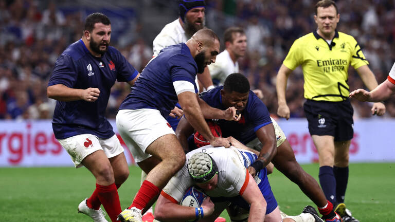 Namibia's lock Adriaan Ludick (bottom) is tackled during the France 2023 Rugby World Cup Pool A match between France and Namibia at the Stade de Velodrome in Marseille, southern France on September 21, 2023. (Photo by Anne-Christine POUJOULAT / AFP)