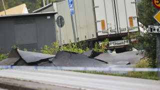 A truck is seen in the debris of a street near Stenungsund, Sweden, on September 23, 2023. The E6 highway near Stenungsund was closed in both directions after persistent rain had caused a large landslide where several cars and a buses went down. Three people were said to be injured. (Photo by Adam IHSE / TT News Agency / AFP) / Sweden OUT