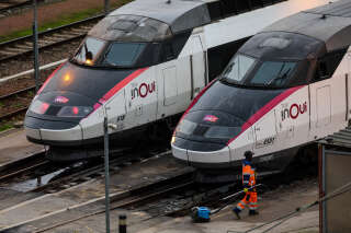 An employee walks near InOui high-speed TGV trains on the Charenton-le-pont railway yard, amid a ticket controller strike in Paris on February 16, 2024. Train stations anticipate possible chaos for the school holiday weekend: only one in two TGVs will run from February 16 to 18, 2024, due to a controllers' strike, according to the SNCF. (Photo by Ian LANGSDON / AFP)