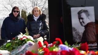 Lyudmila Navalnaya (the woman wearing glasses), mother of late Russian opposition leader Alexei Navalny, accompanied by Alla, mother of Navalny's widow Yulia, visits the grave of her son at the Borisovo cemetery in Moscow on March 2, 2024, the next day after Navalny's funeral. (Photo by Olga MALTSEVA / AFP)