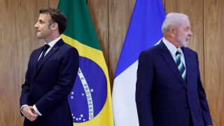 Brazil's President Luiz Inacio Lula da Silva (R) and France's President Emmanuel Macron (L) attend the bilateral agreement signing ceremony at the Planalto Palace in Brasilia on March 28, 2024. (Photo by Ludovic MARIN / POOL / AFP)