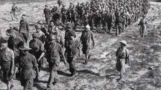 This picture taken in May 1954 shows captured French soldiers, escorted by Vietnamese soldiers, walking to a prisoner camp in Dien Bien Phu. Vietnam will mark 13 March 2004 the 50th anniversary of the start of the siege of Dien Bien Phu, the epic battle that precipitated the collapse of French colonial rule in Indochina. The fighting began March 13, 1954, and 56 days later, 07 May, shell-shocked survivors of the French garnison hoisted the white flag to signal the end to one of the greatest battles of the 20th century. EDITOR'S NOTE: THE VAST MAJORITY OF VIETNAMESE PHOTOS OF THE BATTLE ARE RECONSTRUCTIONS DONE FOR THE PURPOSE OF PROPAGANDA. MOST OF THEM WERE TAKEN JUST HOURS AFTER THE ACTUAL EVENTS DEPICTED.      AFP PHOTO/VNA/FILES (Photo by VNA FILES / AFP)