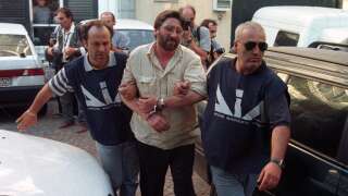 This photo taken in July 1998 shows Francesco Schiavone, one of the main mafia bosses of the Casalesi Camorra clan, during his arrest by Italian police officers in the Castle di Principe.