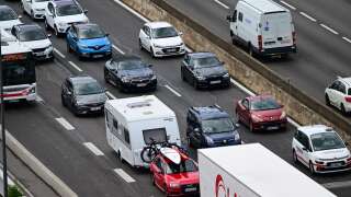 Vehicles queue in traffic on the A7 highway at the southern entrance of Lyon, amid the second peak of summer travels in France, on August 4, 2023. (Photo by Emmanuel DUNAND / AFP)
