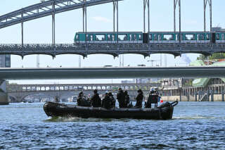 French police personnel manouver a Zodiac boat on the River Seine in Paris on July 17, 2023, to test 