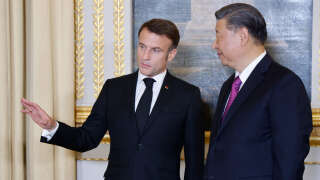 France's President Emmanuel Macron (L) speaks with Chinese President Xi Jinping (R) during presentations ahead of an official state dinner as part of the Chinese president's two-day state visit to France, at the Elysee Palace in Paris, on May 6, 2024. The French president hosts his Chinese counterpart for a state visit on May 6, 2024, seeking to persuade the Chinese leader to shift positions over Russia's invasion of Ukraine and also imbalances in global trade. (Photo by Ludovic MARIN / POOL / AFP)