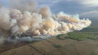 This aerial handout picture courtesy of the Alberta Wildfire Service, taken May 10, 2024, shows smoke from wildfires burning in the Grande prairie forest area, 4 kilometers east of the town of Teepee Creek, in Alberta, Canada. Thousands of people fled their homes on May 12, 2024 in western Canada as hundreds of wildfires beginning earlier than usual portend a difficult fire season. (Photo by Handout / Alberta Wildfire Service / AFP) / RESTRICTED TO EDITORIAL USE - MANDATORY CREDIT 