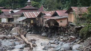 Damaged houses are seen after flash floods and cold lava flow from a volcano in Tanah Datar, West Sumatra, on May 12, 2024. At least 34 people have died and 16 more were missing after flash floods and cold lava flow from a volcano hit western Indonesia, a local disaster official said on May 12. (Photo by REZAN SOLEH / AFP)