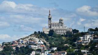 French 19th-century three-masted barque Belem sails near the coast of Marseille and Notre-Dame de la Garde basilica (background), in the Mediterranean Sea, on May 8, 2024, before landing with the Olympic torch, ahead of the Paris 2024 Olympic and Paralympic Games. The Belem is set to reach Marseille on May 8 and ten thousand torchbearers will then carry the flame across 64 French territories. It will travel through more than 450 towns and cities, and dozens of tourist attractions during its 12,000-kilometre (7,500-mile) journey through mainland France and overseas French territories in the Caribbean, Indian Ocean and Pacific. On July 26 it will form the centrepiece of the Paris Olympics opening ceremony. (Photo by CHRISTOPHE SIMON / AFP)