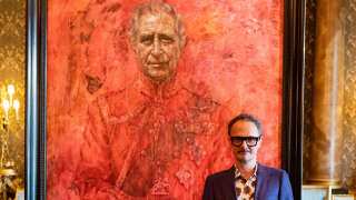 Artist Jonathan Yeo stands in front of his official portrait of Britain's King Charles III wearing the uniform of the Welsh Guards, of which he was made Regimental Colonel in 1975, in the Blue Drawing Room at Buckingham Palace in London on May 14, 2024. The official portrait was commissioned in 2020 to celebrate the then Prince of Wales's 50 years as a member of The Drapers' Company in 2022. Artist Jonathan Yeo had four sittings with the King Charles III, beginning when he was Prince of Wales in June 2021 at Highgrove, and later at Clarence House. The last sitting took place in November 2023 at Clarence House. Yeo also worked from drawings and photography he took, allowing him to work on the portrait in his London studio between sittings. The canvas size - approximately 8.5 by 6.5 feet when framed - was carefully considered to fit within the architecture of Drapers' Hall and the context of the paintings it will eventually hang alongside. (Photo by Aaron Chown / POOL / AFP) / RESTRICTED TO EDITORIAL USE - MANDATORY MENTION OF THE ARTIST UPON PUBLICATION - TO ILLUSTRATE THE EVENT AS SPECIFIED IN THE CAPTION