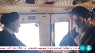 This grab taken from handout video footage released by the IRINN Iranian state television network on May 19, 2024 shows Iran's President Ebrahim Raisi (L) with an unidentified memeber of his delegation on board a helicopter in the Jolfa region of the western province of East Azerbaijan. A helicopter in the convoy of the Iranian president was involved in 