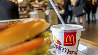 A container with a drink is served at the McDonald's fast-food outlet on February 26, 2015 in Lille, northern France. Several labour unions and a charity have formally accused McDonald's of cheating the French tax payer of hundred of millions of dollars by siphoning off European earnings through a Luxembourg unit over a five-year period since 2009. AFP PHOTO PHILIPPE HUGUEN (Photo by Philippe HUGUEN / AFP)
