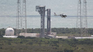 CAPE CANAVERAL, FLORIDA - JUNE 01: A security helicopter flies past Boeing’s Starliner spacecraft before its flight was scrubbed as it sits atop a United Launch Alliance Atlas V rocket at Space Launch Complex 41 on June 01, 2024, in Cape Canaveral, Florida. NASA’s Boeing Crew Flight Test has been scrubbed multiple times as they attempt to send two astronauts to the International Space Station.   Joe Raedle/Getty Images/AFP (Photo by JOE RAEDLE / GETTY IMAGES NORTH AMERICA / Getty Images via AFP)